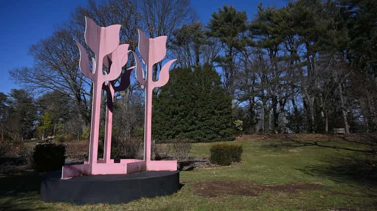 A sculpture welcomes guests to Albertson's 12-acre Clark Botanic Garden.