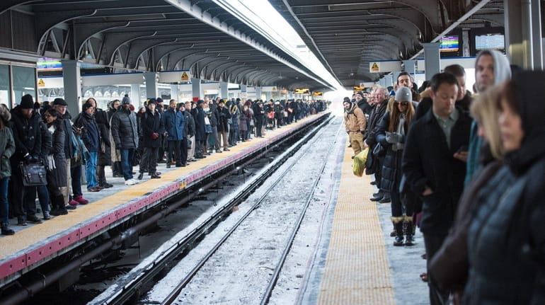 Commuters wait on both platforms for a westbound Long Island...
