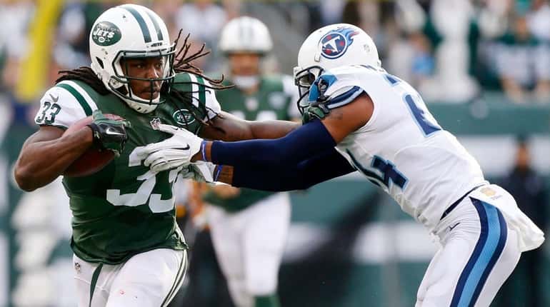 Chris Ivory carries the ball in the first half as...