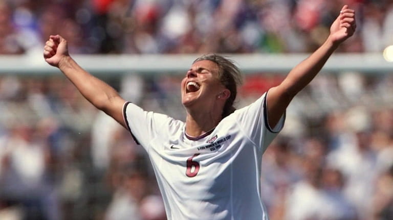 USA's Brandi Chastain celebrates after kicking the game-winning overtime penalty...