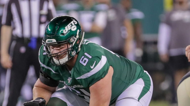 Jets offensive guard Alex Lewis lines up during the first half...