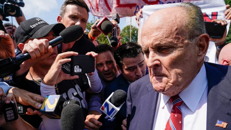 Rudy Giuliani speaks outside the Fulton County jail, Wednesday, Aug....