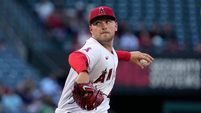 Los Angeles Angels starting pitcher Reid Detmers throws to the...