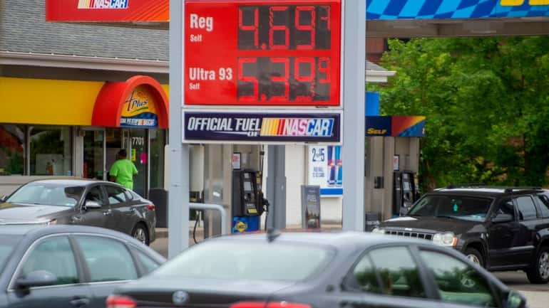 Cars drive past the gas station Monday, in Pittsburgh.