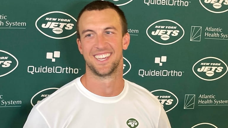 Jets quarterback Trevor Siemian smiles while speaking with reporters at...