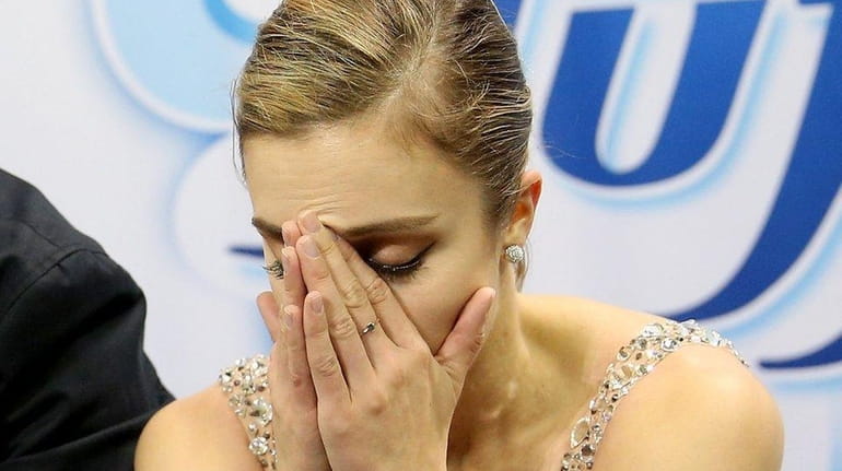 Ashley Wagner waits for her score in the kiss and...