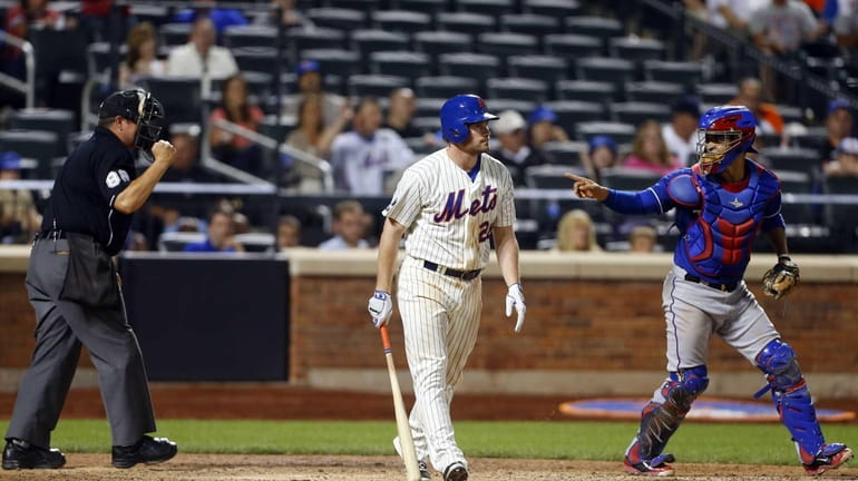 Daniel Murphy of the Mets strikes out to end a...