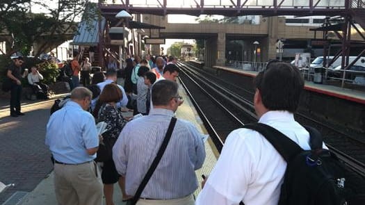 Commuters wait for trains at the Mineola LIRR station. (Aug....