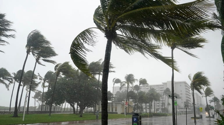 An approaching tropical storm drenches Ocean Drive on Miami Beach...