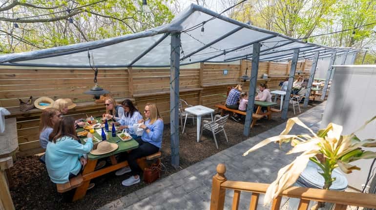 Patrons dine on the outdoor patio at Barrow Food House...