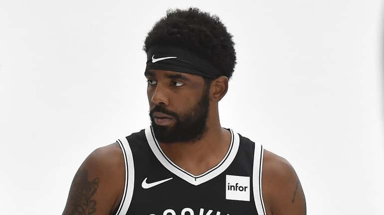 Kyrie Irving poses for pictures during Nets media day on Friday,...