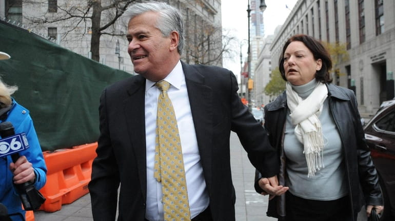 Dean Skelos and his wife Gail on their way to...