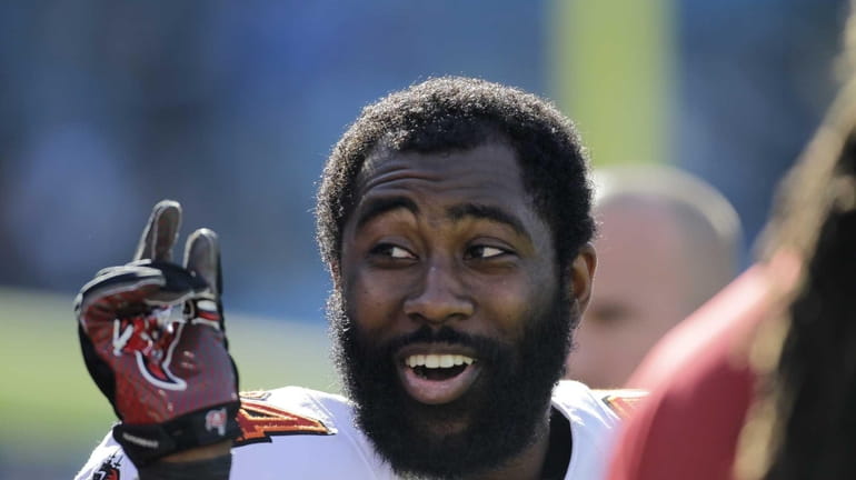 The Tampa Bay Buccaneers' Darrelle Revis clowns around with teammates...