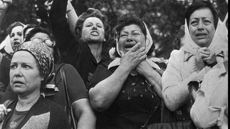 Members of the Mothers of Plaza de Mayo protest in...