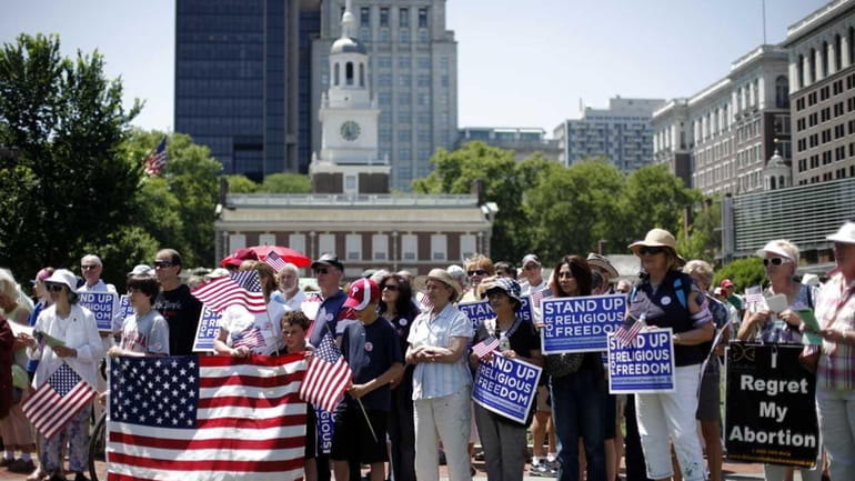 Demonstrators protest against the Obama administration mandate that employers provide...