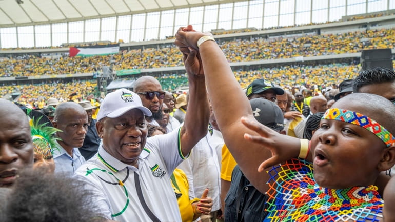 South African President Cyril Ramaphosa, centre left, is greeted by...