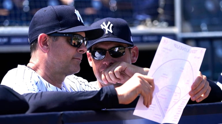 New York Yankees manager Aaron Boone, left, and bench coach...