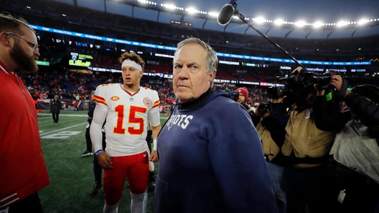 New England Patriots head coach Bill Belichick, center, turns away...