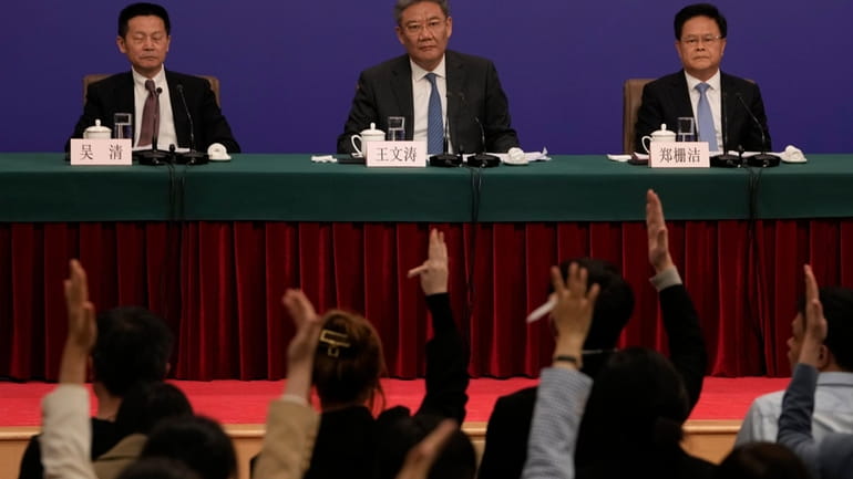 Key Chinese finance and economy officials look on as journalists...