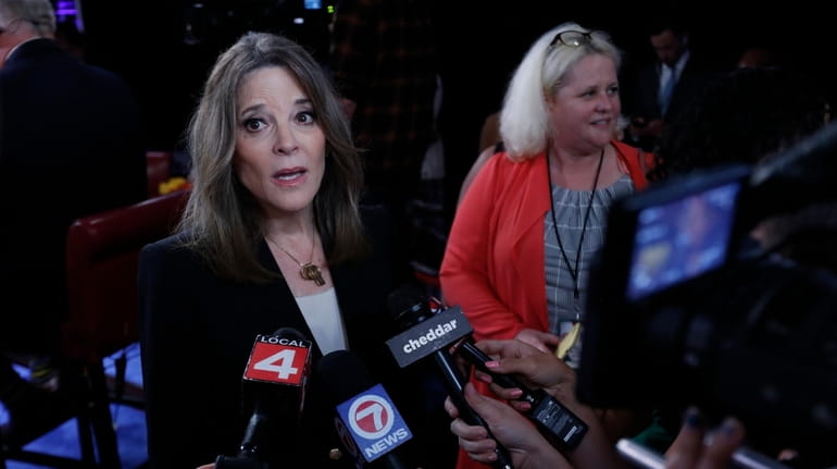 Marianne Williamson talks to reporters after the first of two...