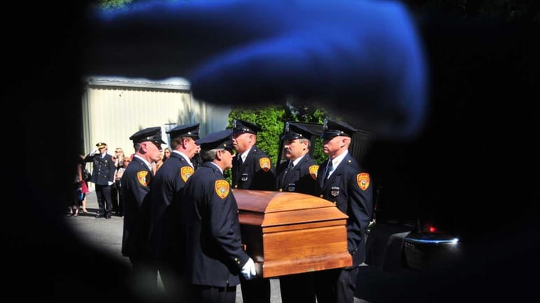 Police officers salute as the coffin of Det. Sgt. Robert...