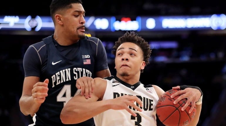 Carsen Edwards, right, who scored 27 points, gets a little...
