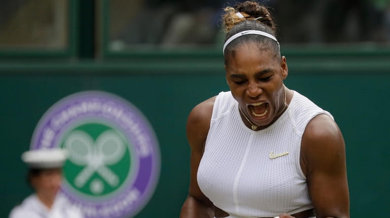 Serena Williams celebrates after winning a point against Alison Riske...