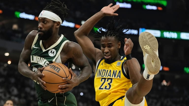 Milwaukee Bucks' Patrick Beverley rebounds in front of Indiana Pacers'...