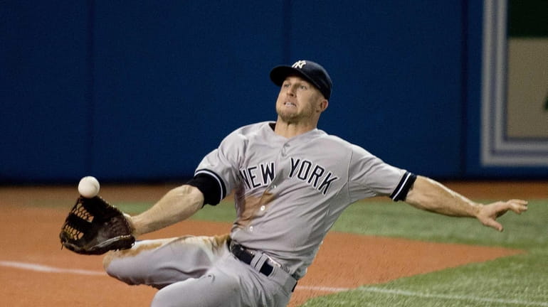 Yankees leftfielder Brett Gardner makes a sliding catch on a...