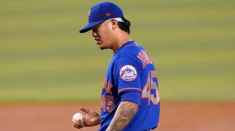 Mets starting pitcher Jordan Yamamoto stands on the mound during...