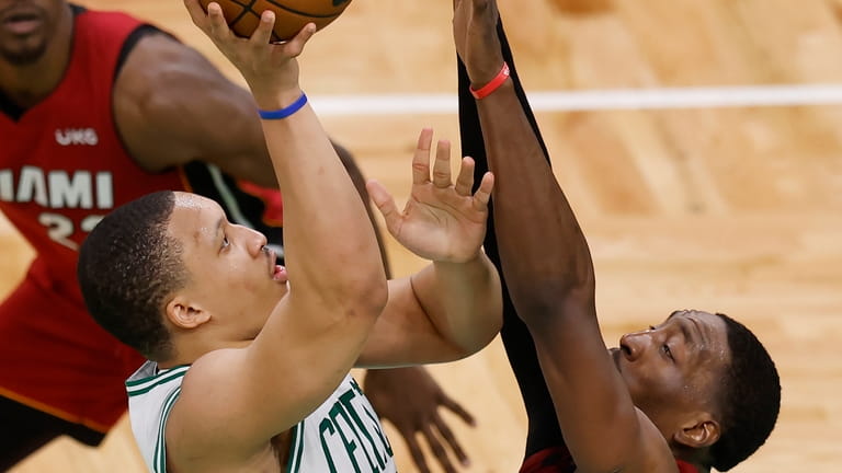 Boston Celtics forward Grant Williams, front left, shoots against Miami...