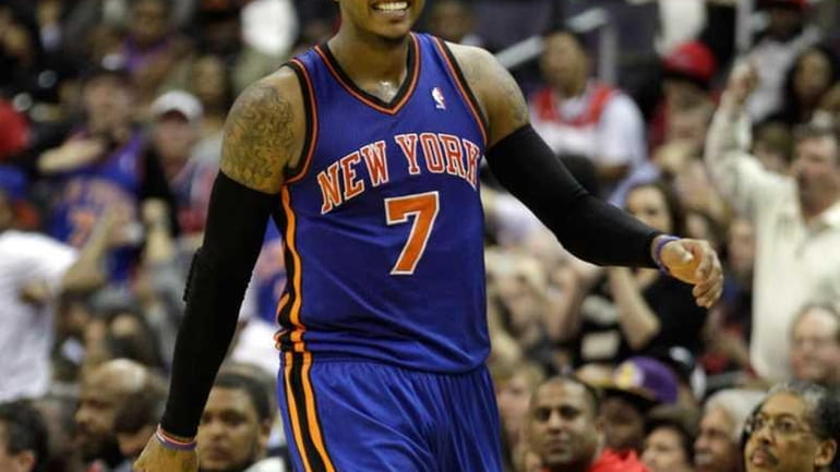 Carmelo Anthony reacts after making a basket during the second...