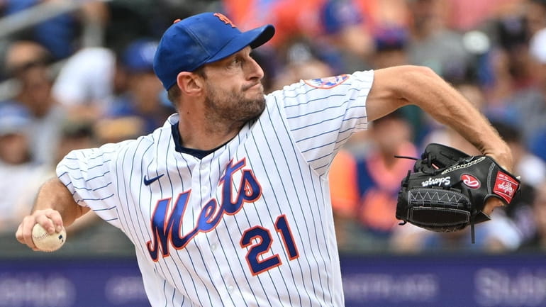 Mets starting pitcher Max Scherzer delivers against the Colorado Rockies...