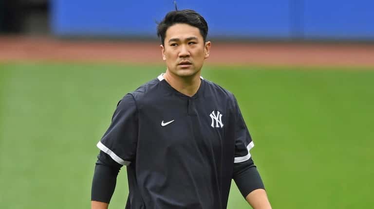 Yankees starting pitcher Masahiro Tanaka walks on the field before...