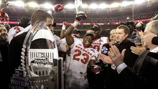 Rutgers running back Jawan Jamison holds up the player of...