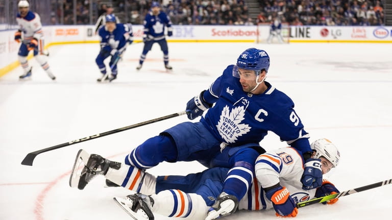Toronto Maple Leafs' John Tavares (91) fights for the puck...