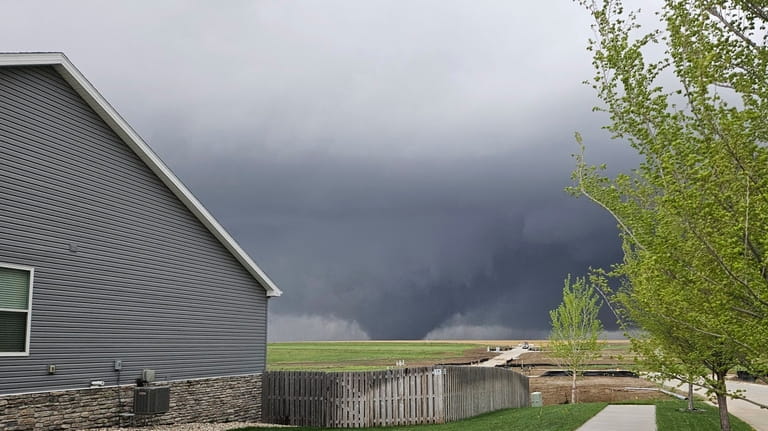 A tornado moves through suburbs northwest of Omaha on Friday,...