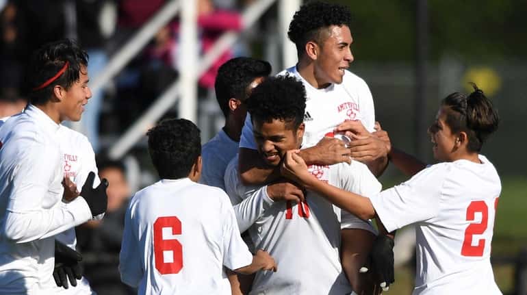 Amityville's team celebrates Marlon Martinez's first of two goals during...
