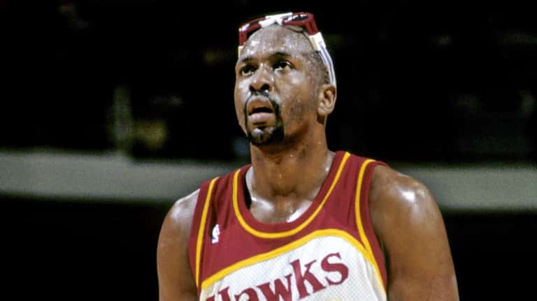 Atlanta Hawks' Moses Malone takes a shot in 1990.