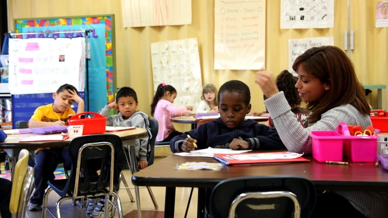 A kindergarten teacher instructs young students at Moriches Elementary School....