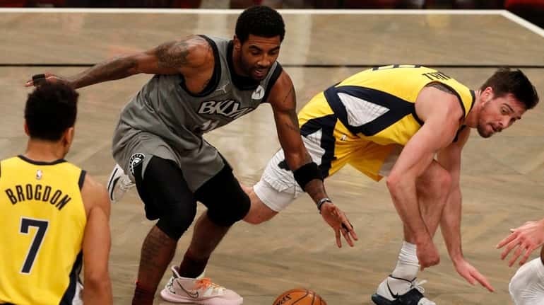 Kyrie Irving of the Nets draws a foul during the fourth...