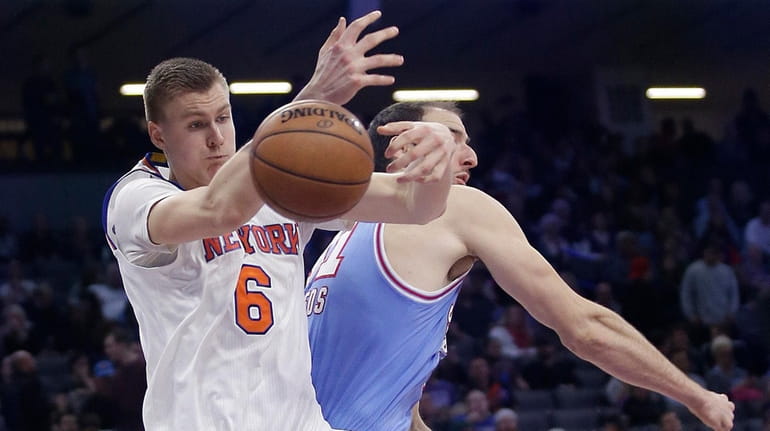 New York Knicks forward Kristaps Porzingis, left, goes for the...