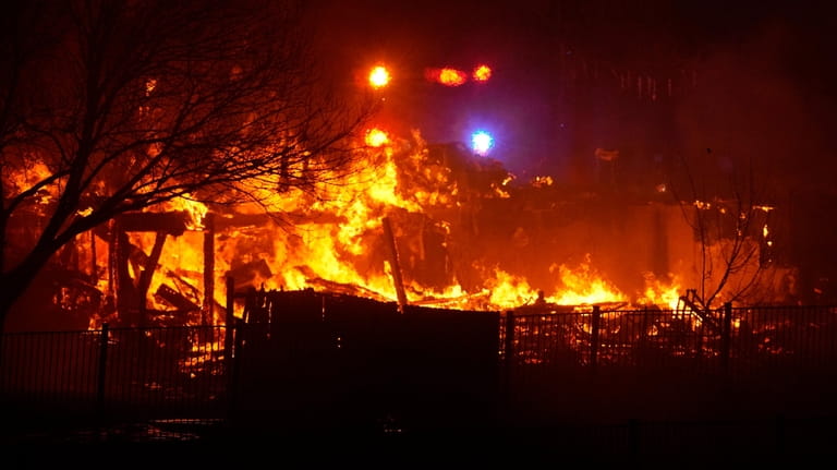 Homes burn as a wildfire rip through a development, Dec....