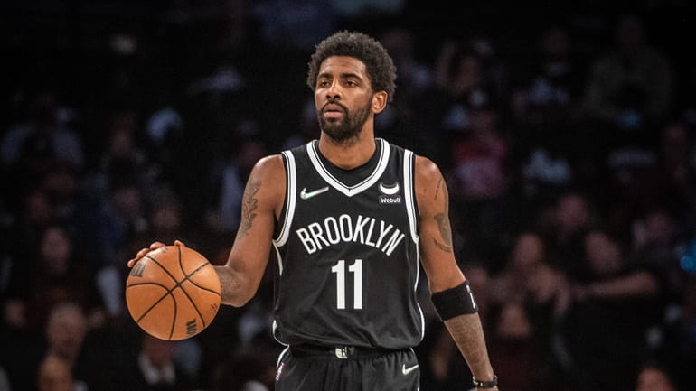 Nets' Kyrie Irving bring the ball upcourt against the Cleveland...