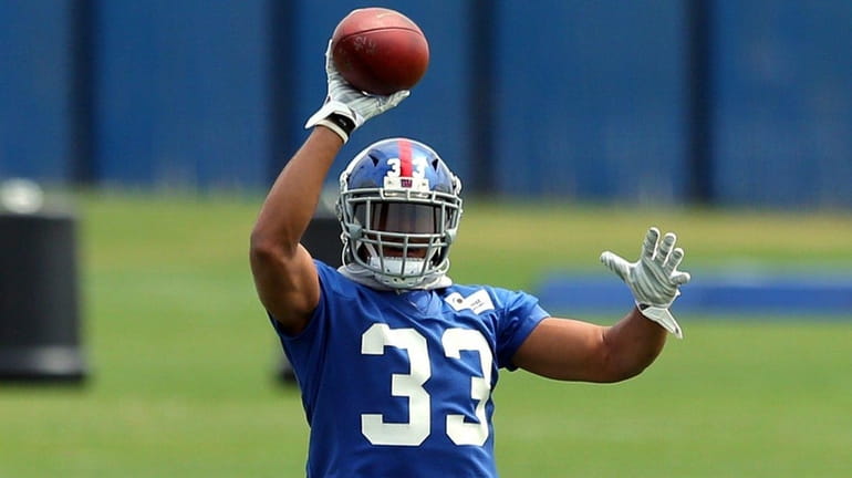 New York Giants safety Andrew Adams (33) catches a ball...