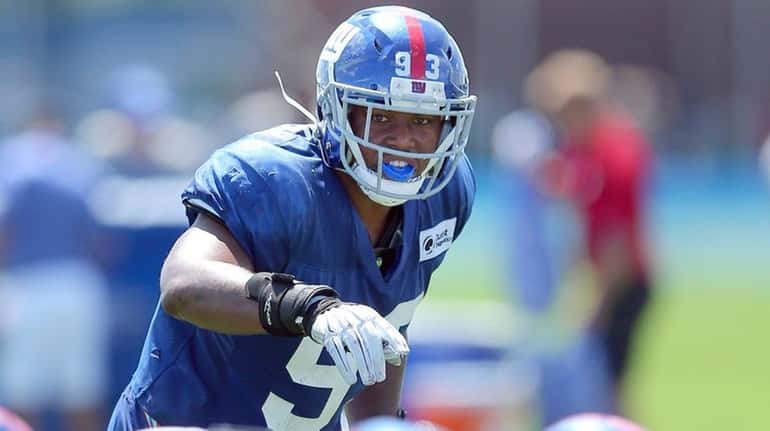Giantslinebacker B.J. Goodson signals to the defense during training camp...
