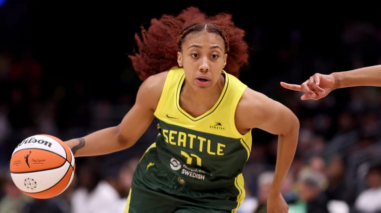 Arella Guirantes #11 of the Seattle Storm dribbles against the...