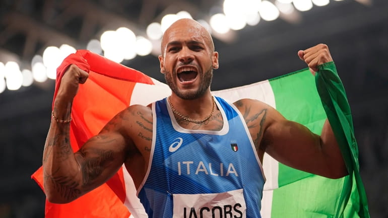Lamont Marcell Jacobs, of Italy celebrates after winning the gold...
