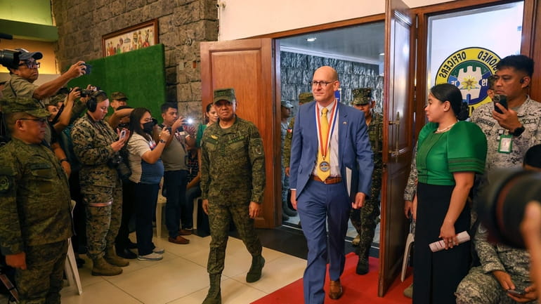 Philippines' military Chief Gen. Romeo Brawner Jr., center left, and...