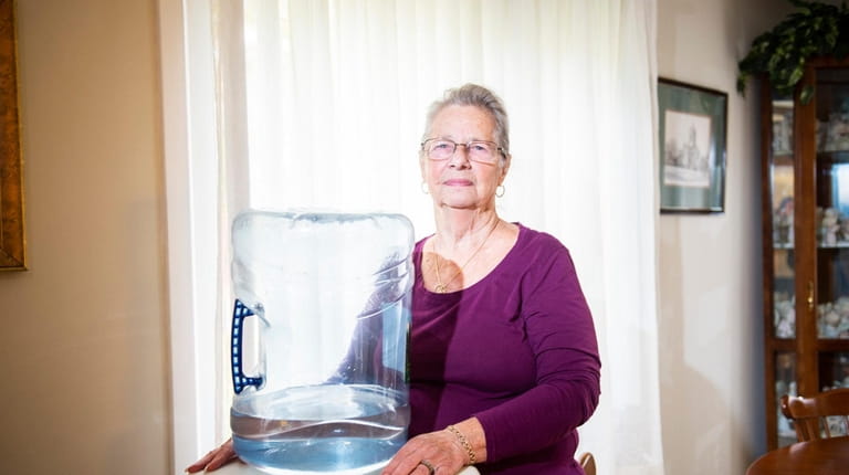 Homeowner Lucille Morreale with the bottled water dispenser she and her...